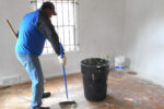 9 13 14 Kenny sweeps up house debris